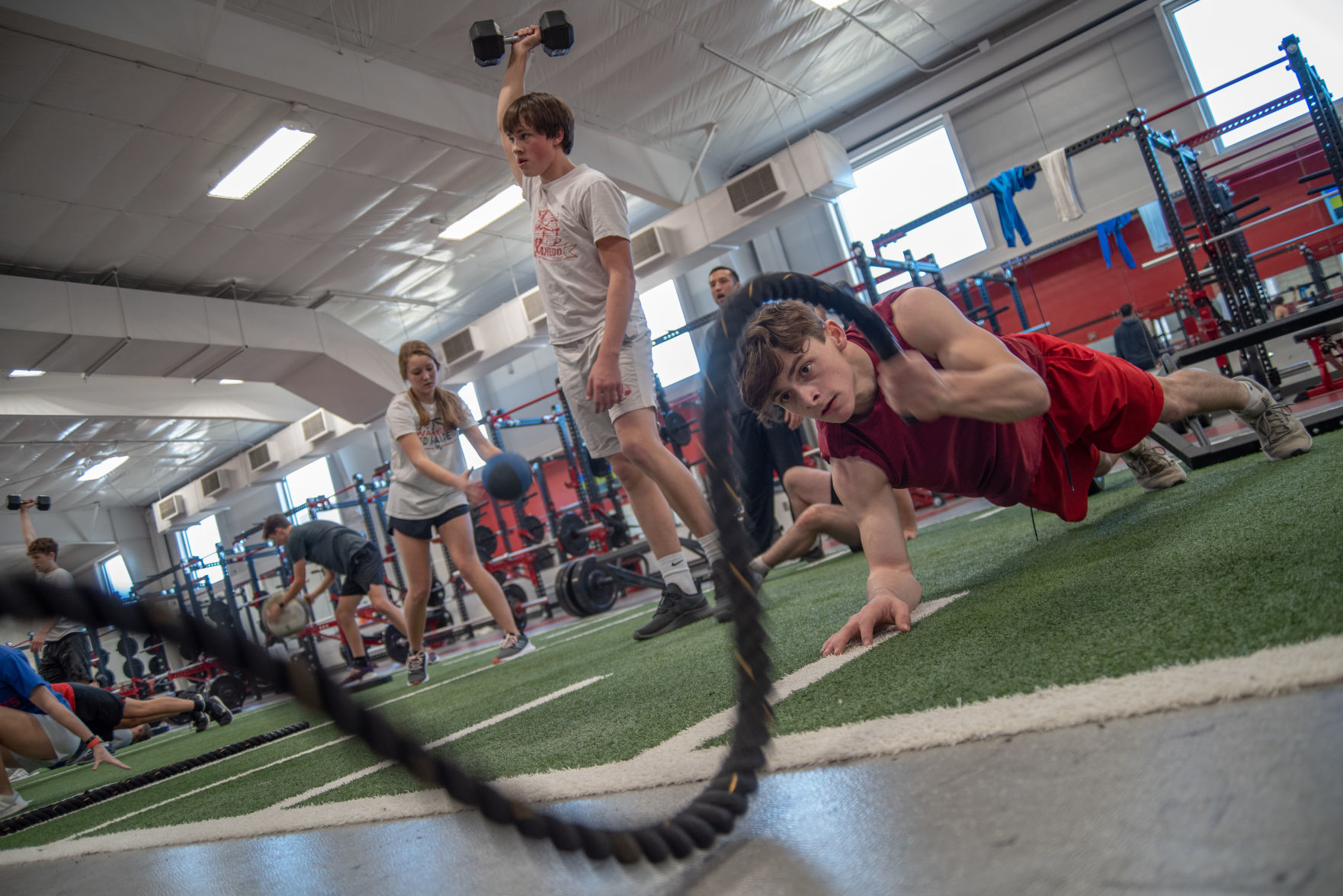 Taylor Beck works out using the battle ropes during Weston MoodyÕs health and performance class at Wamego High School on Thursday, February 6, 2020.